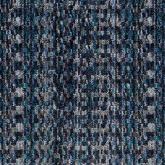 Moire fabric sample, navy blue and gray with turquoise accents, displaying a dense, textured, pixelated square and rectangle motif.